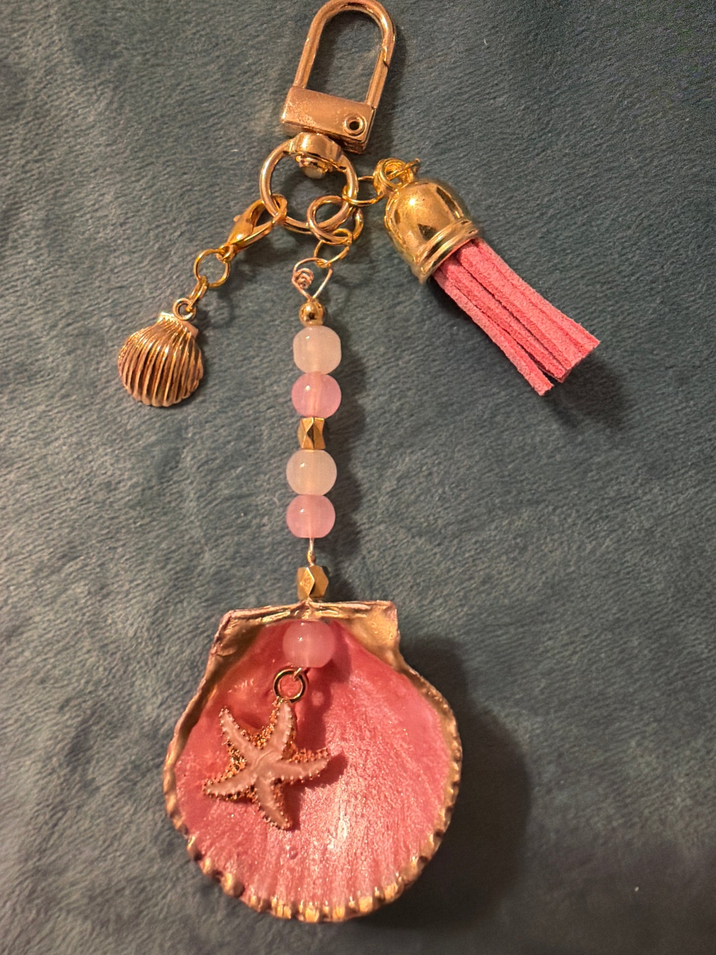Pink and gold starfish charm in a calico scallop