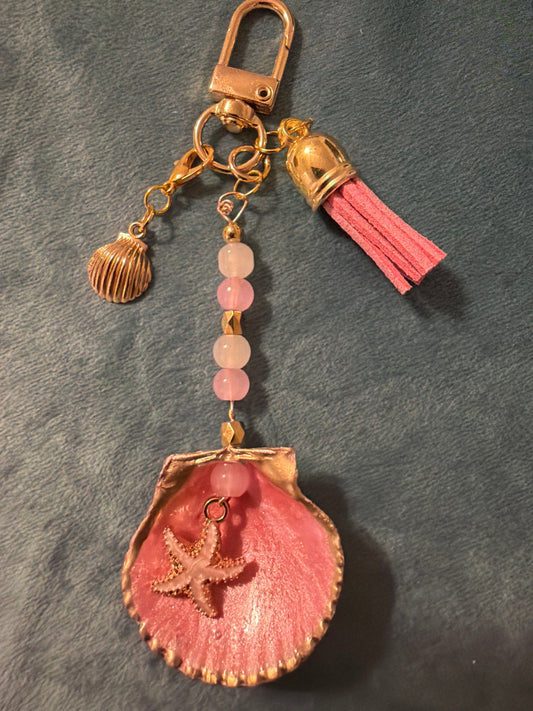 Pink and gold starfish charm in a calico scallop
