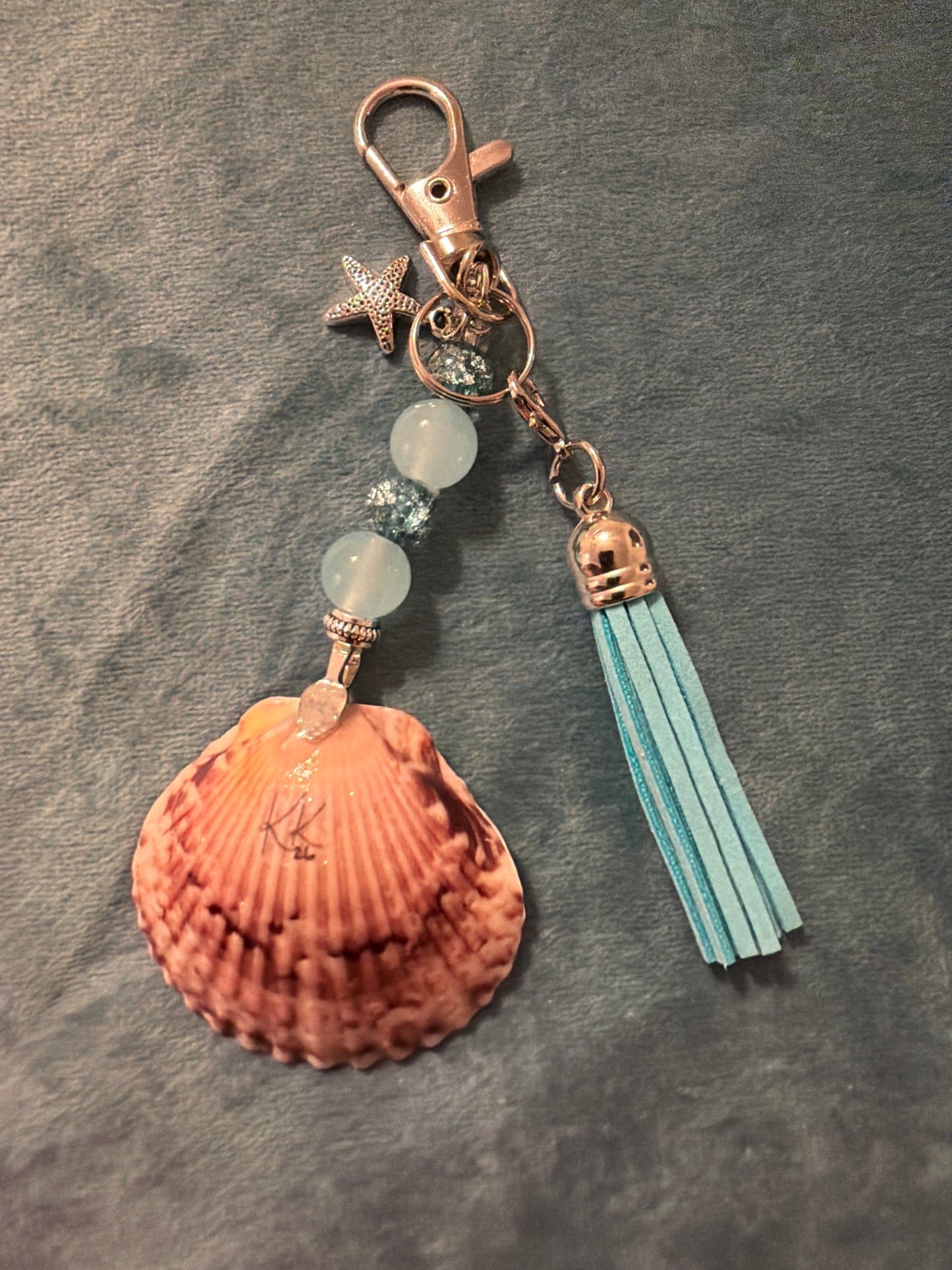 Starfish design on a small calico scallop shell