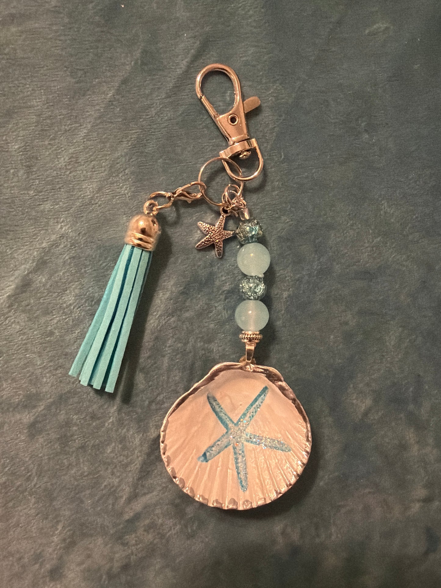 Starfish design on a small calico scallop shell