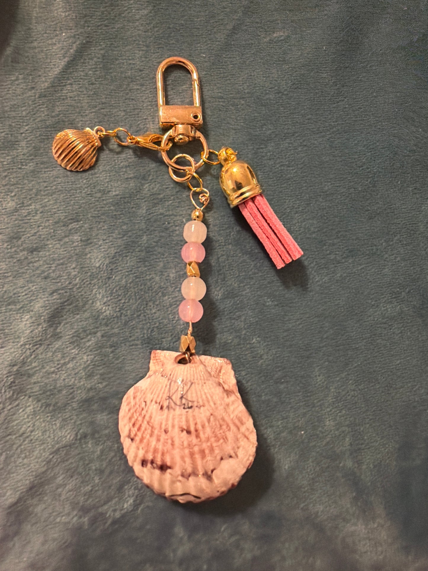 Pink and gold starfish charm in a calico scallop