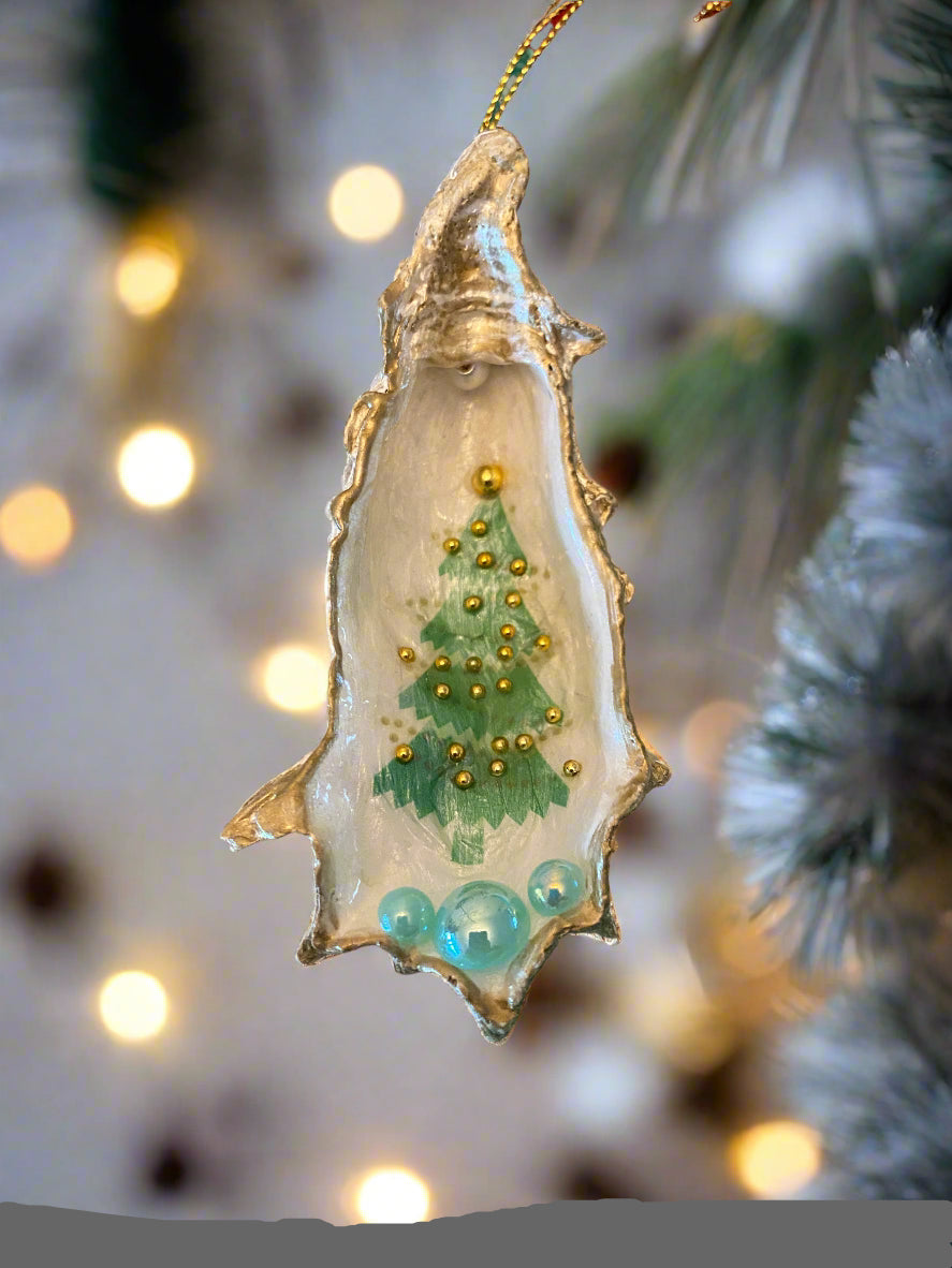 Decorative oyster shell with greenery and beads on a beige background