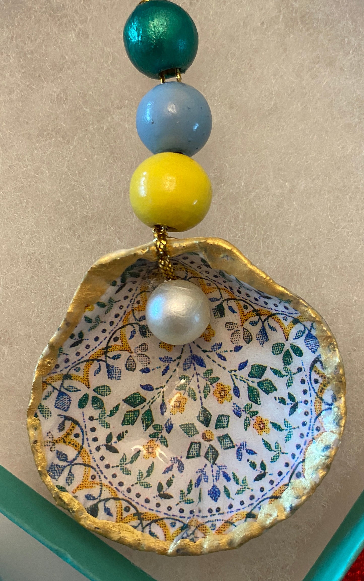 Tiny flower design with pearl on small scallop shell