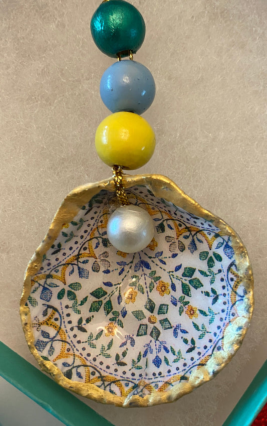 Tiny flower design with pearl on small scallop shell