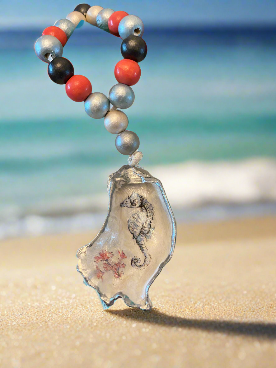 Decorative keychain with seahorse design on a beach