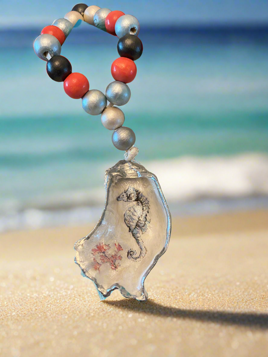 Decorative keychain with seahorse design on a beach