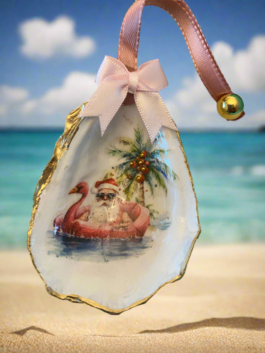 Decorative oyster shell with a painted design and pink ribbon