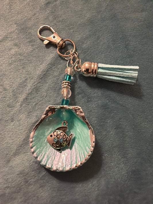 Silver fish embellishment on a calico scallop