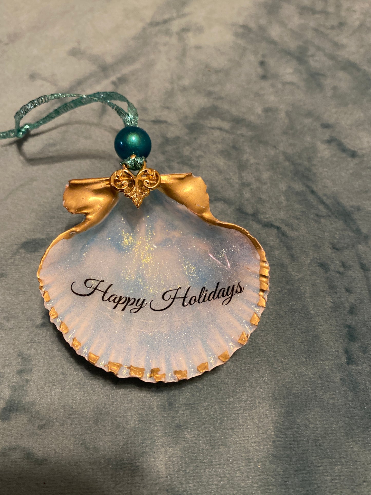 “Happy Holidays” with blue shimmer background -scallop shell