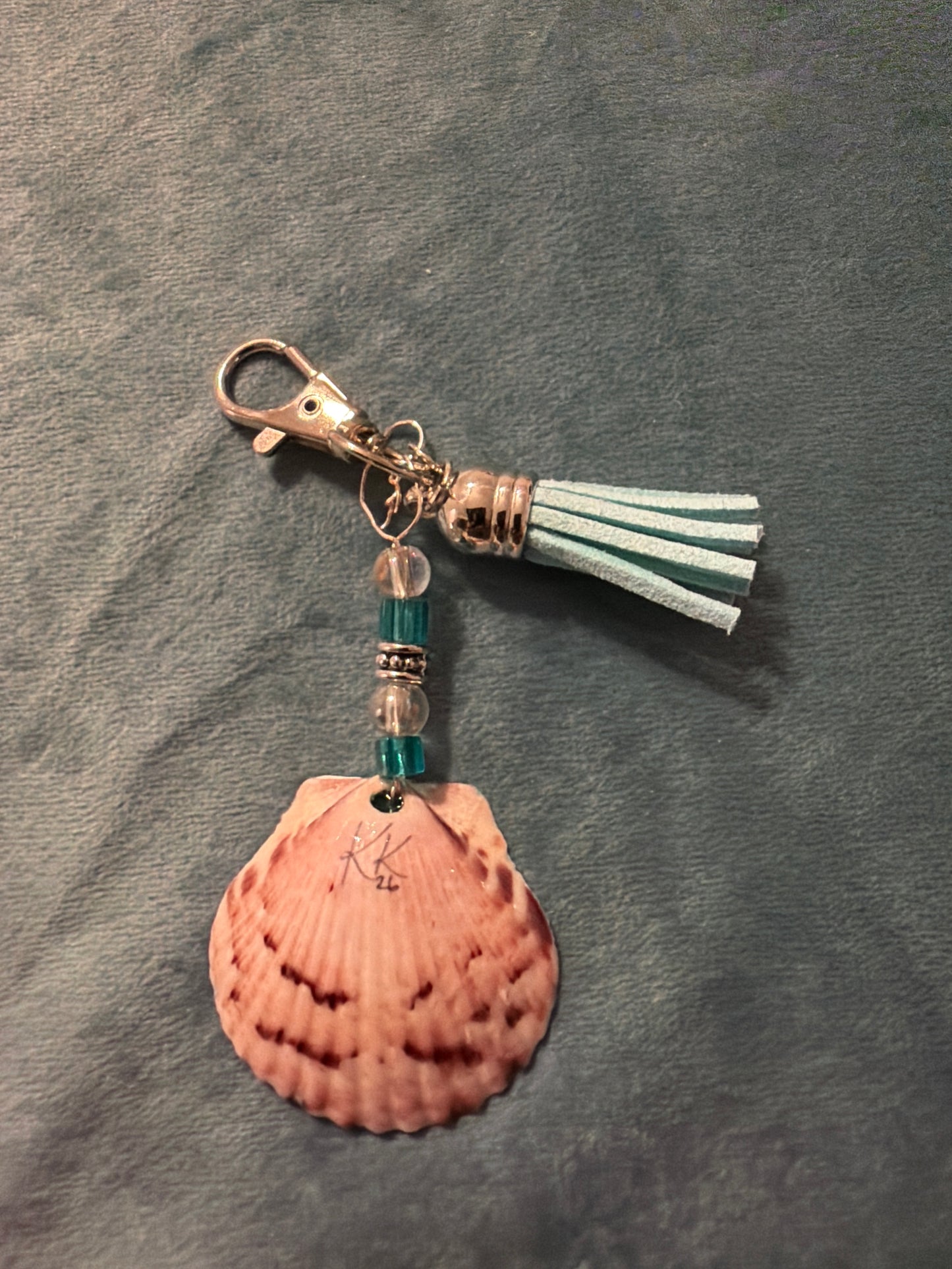 Silver fish embellishment on a calico scallop