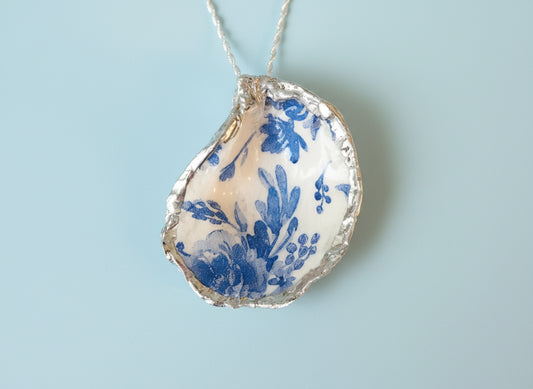 Decorative oyster shell with blue floral pattern 