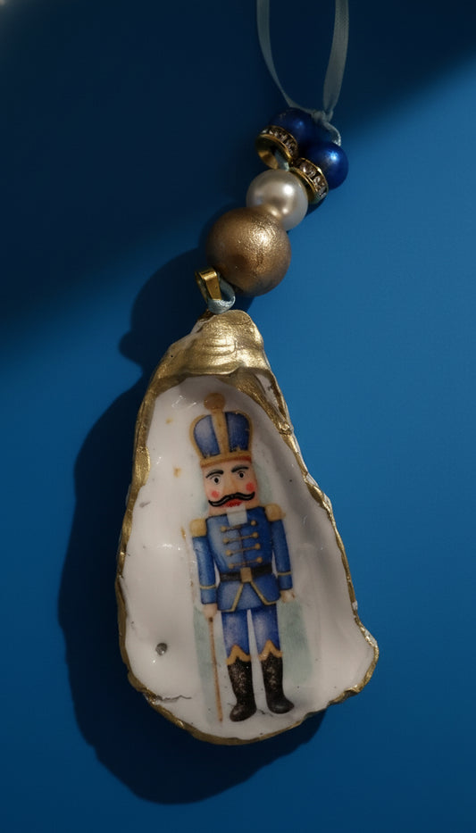 Decorative ornament with a nutcracker figure inside an oyster shell 